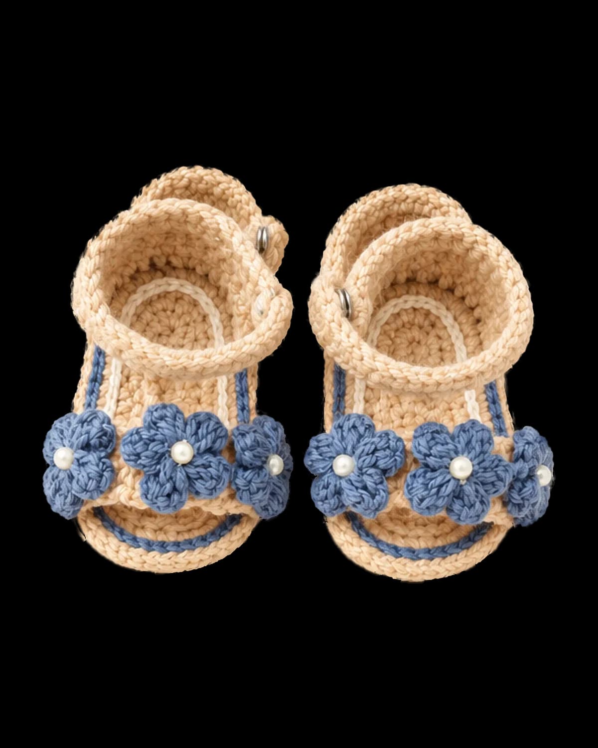 Pair of beige crochet baby sandals with three dusty-blue puff flowers with pearl centres on the toe strap