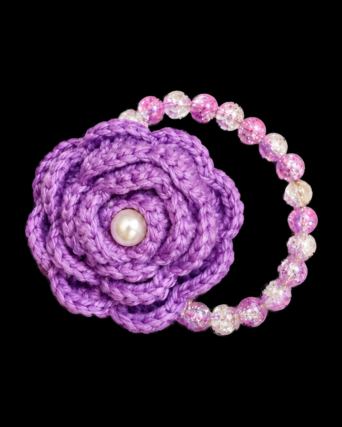 Lilac crochet rose with a white pearl centre on a stretch bracelet of lilac and clear crackle-glass beads, on a cream background