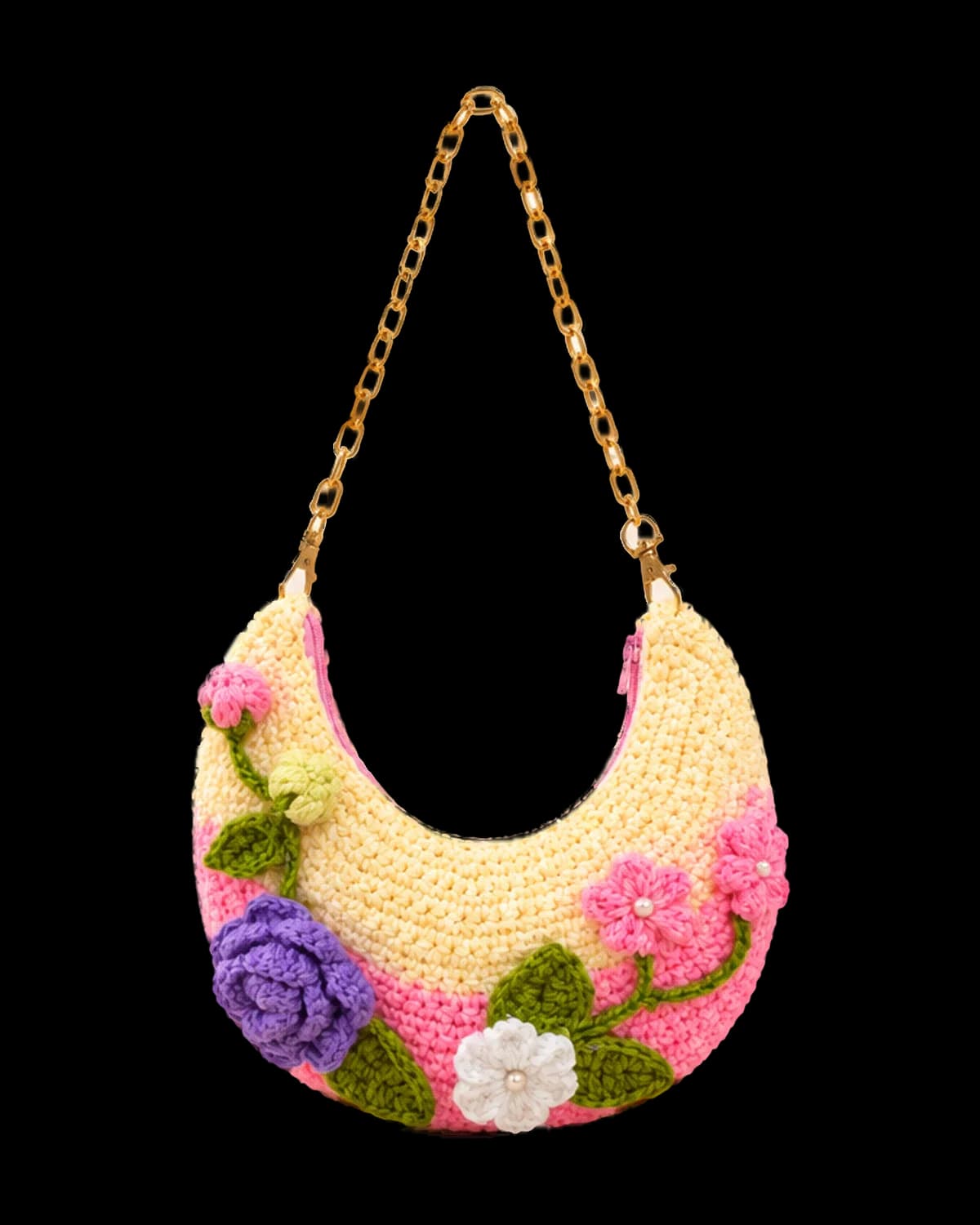 Handmade crochet crescent shoulder bag in butter cream and pink with a purple rose, pearl-centred flowers and a gold-tone chain strap