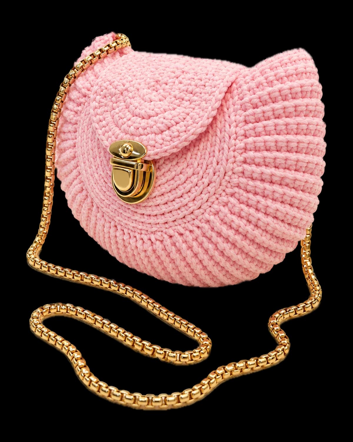 Pink crochet seashell bag with a gold-tone push-lock clasp and gold box-chain strap on a cream background