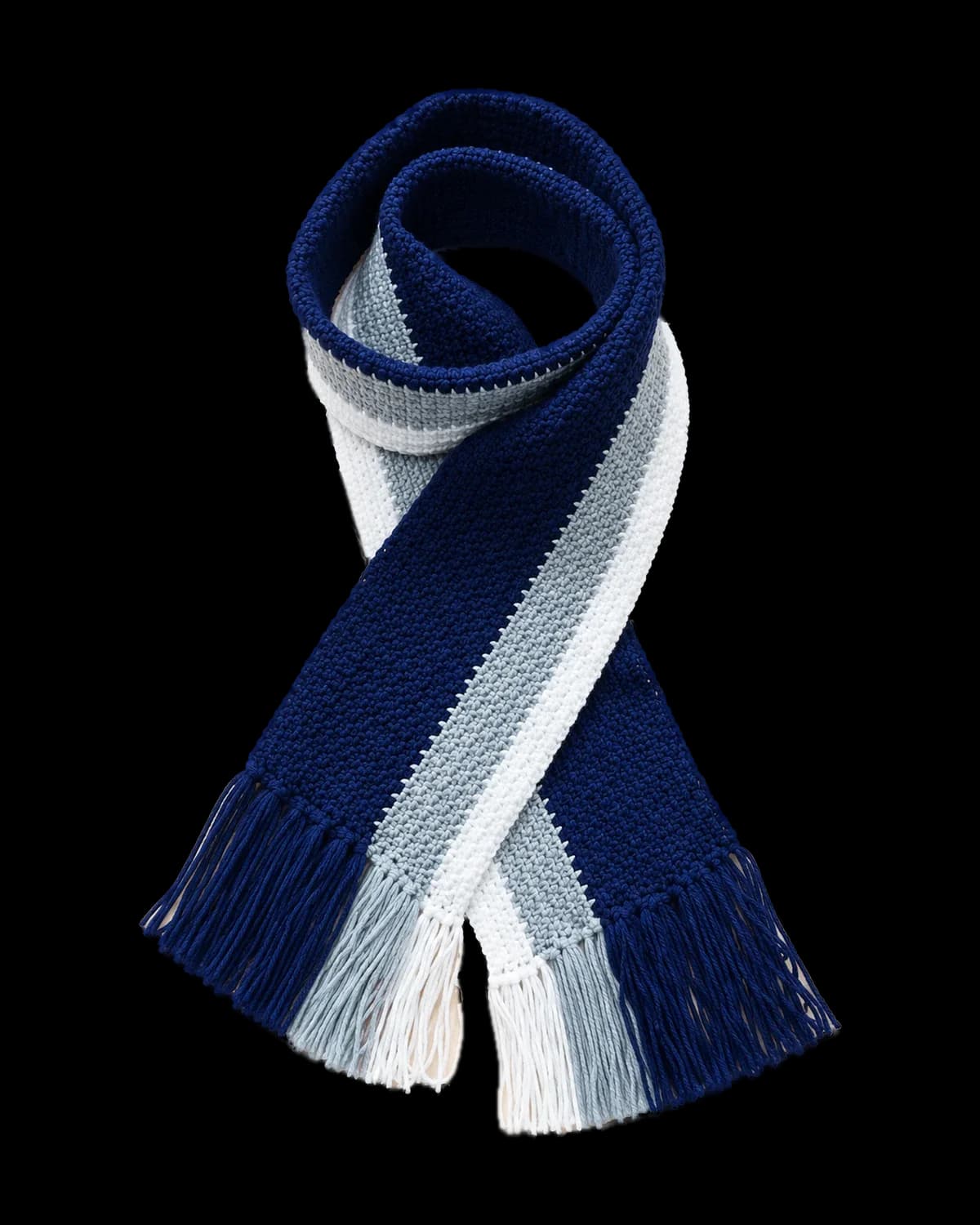 Navy, grey and white striped crochet scarf with tassel fringe, looped on a cream background